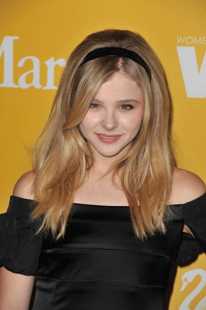 Chloe Grace Moretz was at the Women in Film 2012 Crystal + Lucy Awards at the Beverly Hilton Hotel on June 13, 2012. She was charming in a black dress to pair with her black headband on her long sandy blonde layered hairstyle that has long side-swept bangs.