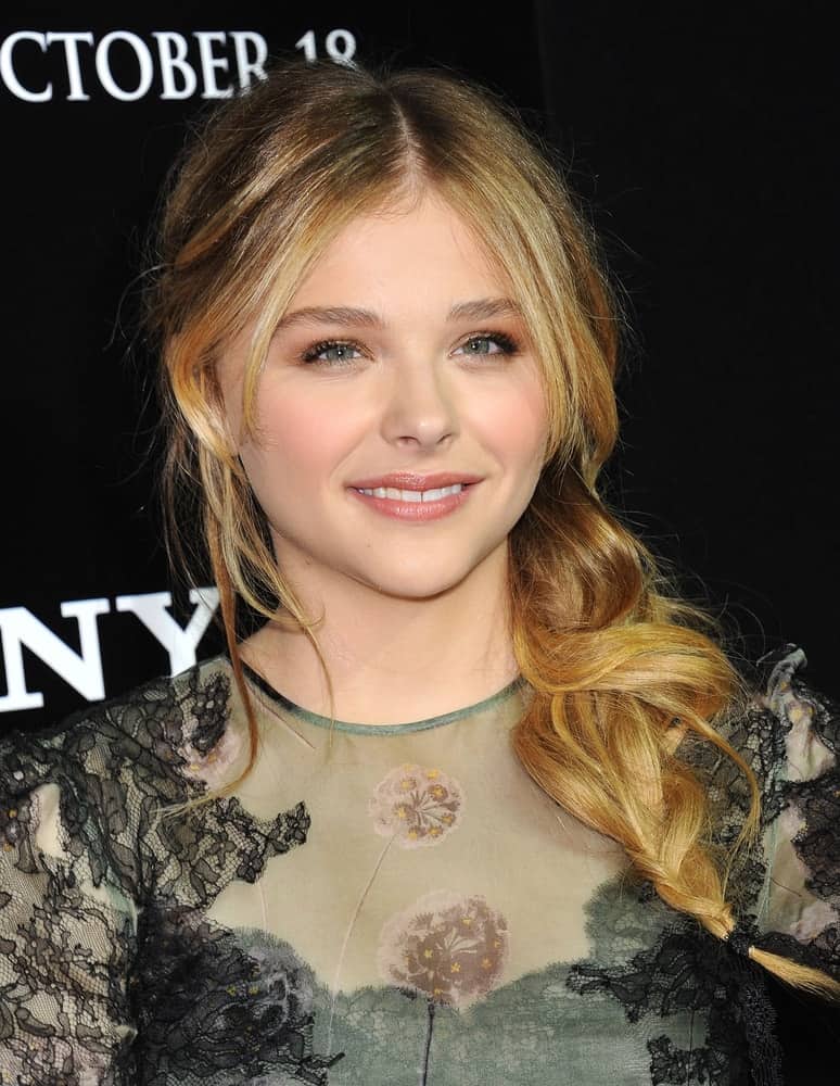 Chloe Grace Moretz attended the "Carrie" World Premiere on October 7, 2013 in Hollywood, CA. She wore a sheer green dress that went well with her side-swept wavy sandy blonde hairstyle with layers and highlights.