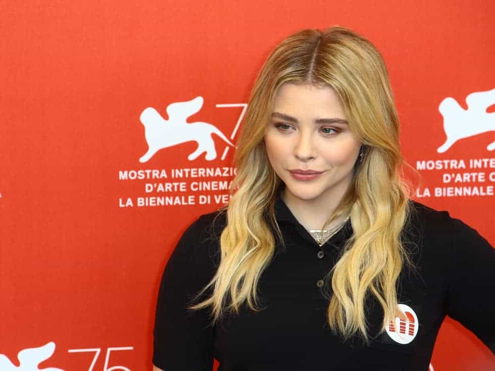 Chloe Grace Moretz attended the 'Suspiria' photocall during the 75th Venice Film Festival at Sala Casino on September 1, 2018, in Venice, Italy. She wore a black casual outfit to pair with her layered and highlighted sandy blonde hairstyle with waves.