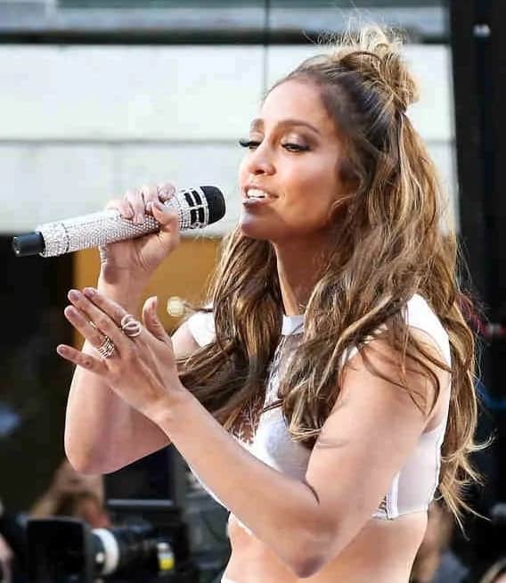 Jennifer Lopez wears a messily tousled half-up bun half down hairstyle as she performs onstage at the NBC's Today Show on July 11, 2016.
