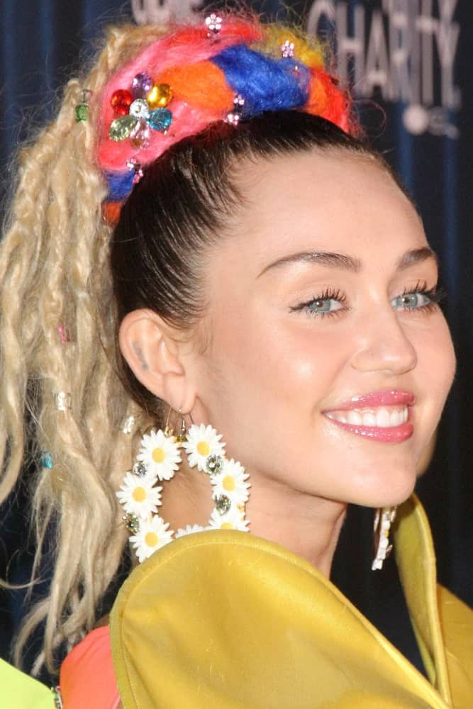Miley Cyrus wore a colorful outfit with her high ponytail that has blond dyed braids at the Hilarity for Charity's James Franco's Bar Mitzvah at the Hollywood Paladium on October 17, 2015 in Los Angeles, CA.