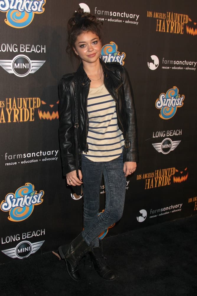 Sarah Hyland attended the 4th Annual Los Angeles Haunted Hayride VIP Premiere Night at Griffith Park on October 7, 2012 in Los Angeles, CA. She wore a cool leather jacket with her casual outfit and topped it off with a messy top knot bun hairstyle with tendrils loose.