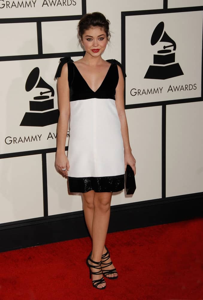 Sarah Hyland was at the 56th Annual Grammy Awards Arrivals on January 26, 2014 in Los Angeles, CA. She was lovely in her simple black and white dress that she paired with a messy bun hairstyle with loose tendrils.