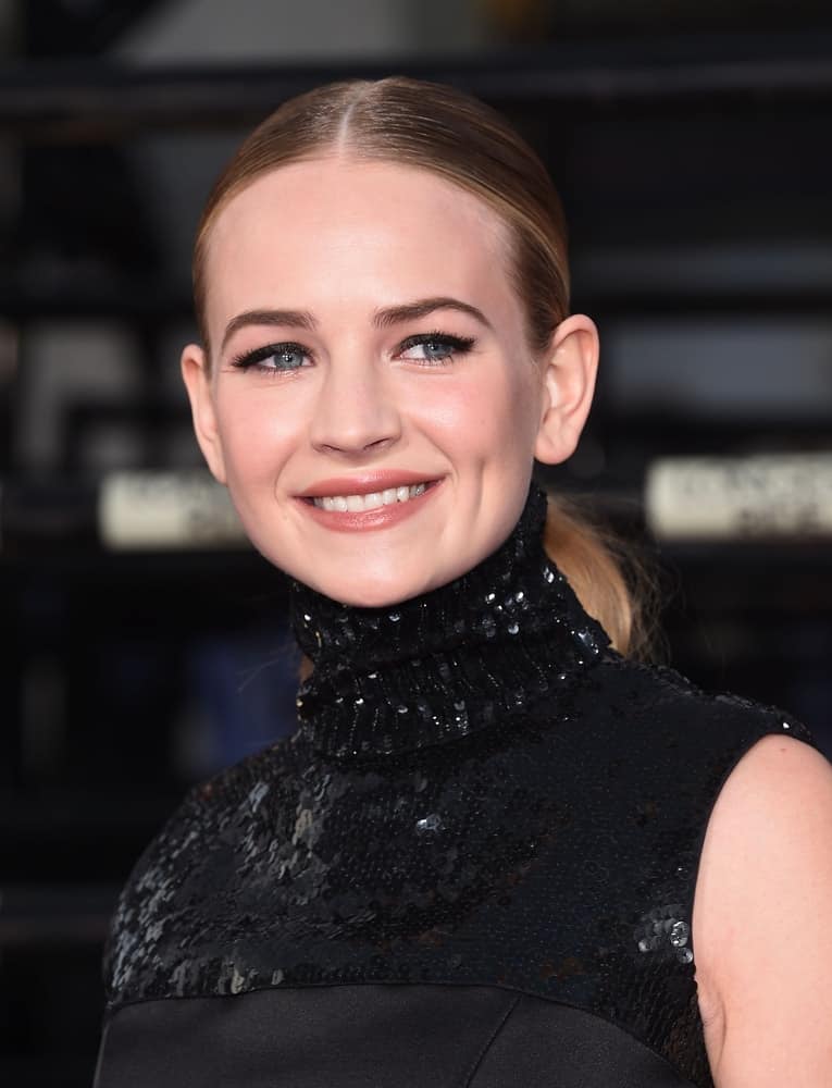 The young actress pulled her blonde wavy locks tightly into a middle-parted ponytail at the "The Longest Ride" Los Angeles Premiere on April 06, 2015. The young actress pulled her blonde wavy locks tightly into a middle-parted ponytail at the "The Longest Ride" Los Angeles Premiere on April 06, 2015.