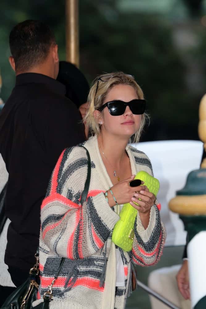 Ashley Benson was at the Venice Film Festival on September 04, 2012 in Venice, Italy. She wore a colorful casual outfit, a pair of cool sunglasses and a messy sandy blonde hairstyle with loose tendrils and side bangs.