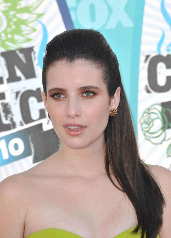 On August 8, 2010, Emma Roberts was at the 2010 Teen Choice Awards at the Gibson Amphitheatre, Universal Studios, Hollywood. She wore a strapless dress that she topped with a raven slicked back straight hairstyle.