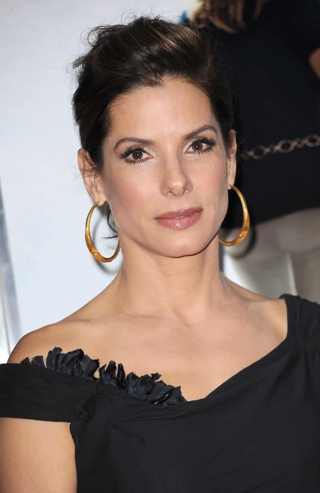 Sandra Bullock was at "The Blind Side" November 17, 2009 Premiere in New York. Her simple black dress was complemented by her elegant neckline and slightly messy upstyle with highlights.