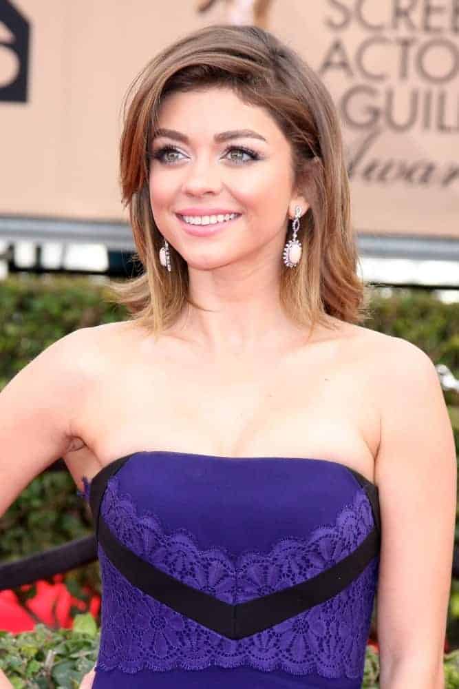 Sarah Hyland attended the 22nd Screen Actors Guild Awards at the Shrine Auditorium on January 30, 2016, in Los Angeles, CA. She was stunning in a strapless purple dress that matches her shoulder-length layered bob hairstyle with long side-swept bangs.