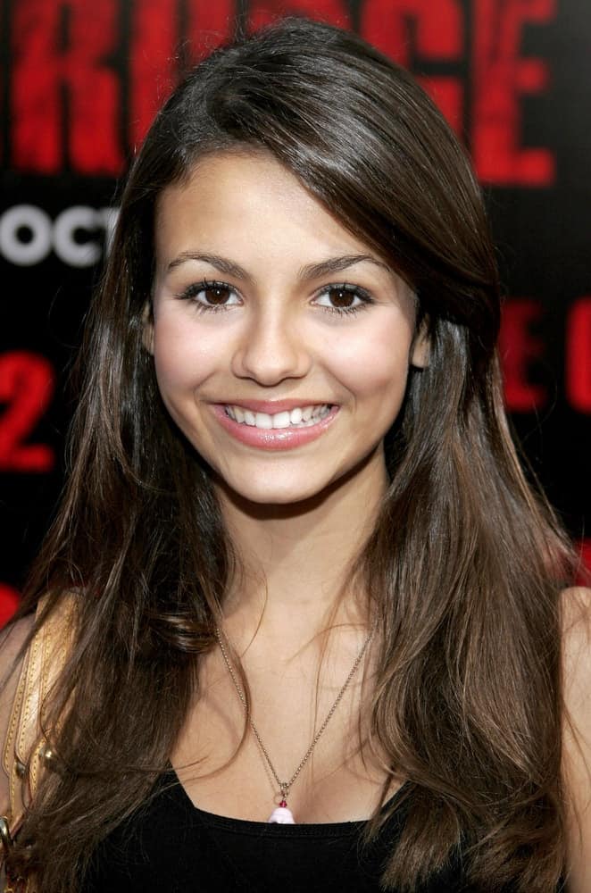On October 8, 2006 in Buena Park, Victoria Justice attends the World Premiere of "The Grudge 2" held at the Knott's Berry Farm in Buena Park, California. She wore a black blouse with her long and layered brunetter hairstyle with long side-swept bangs,