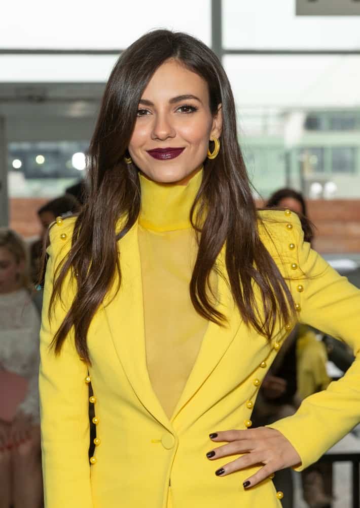 On February 7, 2019, Victoria Justice attended Pamela Roland runway during New York Fall/Winter 2019 fashion week at Pier 59 Studio B. She wore a fashionable yellow outfit with her long and loose brunette hairstyle with layers and long side-swept bangs.