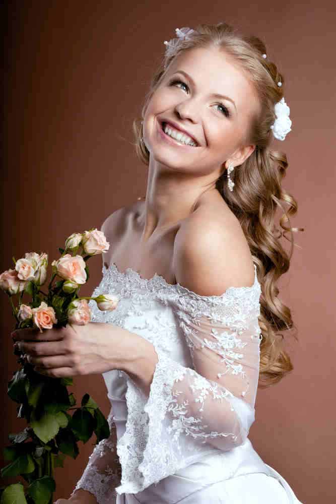 Match you wedding dress and stay confident with this curled half-up half down with flower and pearl accessories. Match you wedding dress and stay confident with this curled half-up half down with flower and pearl accessories.