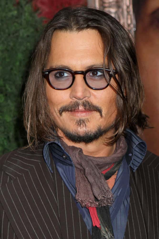 Johnny Depp pulled off a hipster look with long hair, colored sunglasses and some scarves during the New York premiere of