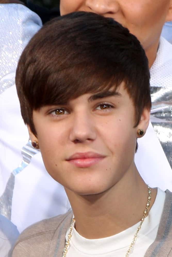 Justin Bieber paired some blings with his rounded haircut during the Michael Jackson Immortalized Handprint and Footprint Ceremony at Graumans Chinese Theater on January 26, 2012 in Los Angeles, CA.