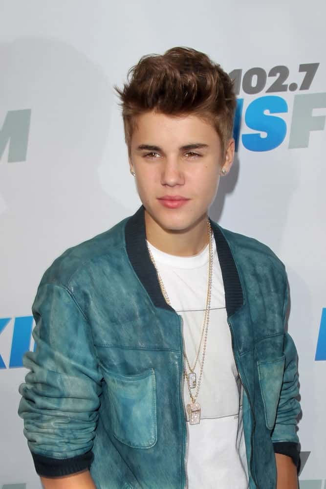 The singer rocked a messy pompadour hairstyle during the "Wango Tango" Concert at The Home Depot Center on May 12, 2012. He finished the look with layered blings and a white top under a teal jacket.