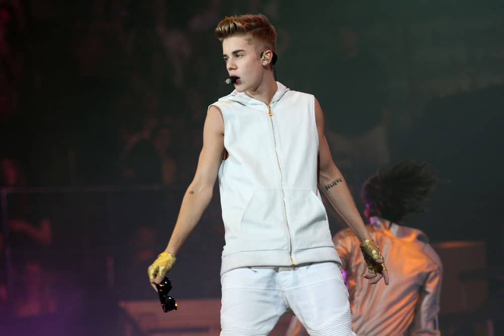 Justin Bieber performing at Madison Square Garden on November 28, 2012 with a neat undercut incorporated with a brushed up hairstyle. It was dyed in chestnut blonde that goes perfectly with his skin tone.
