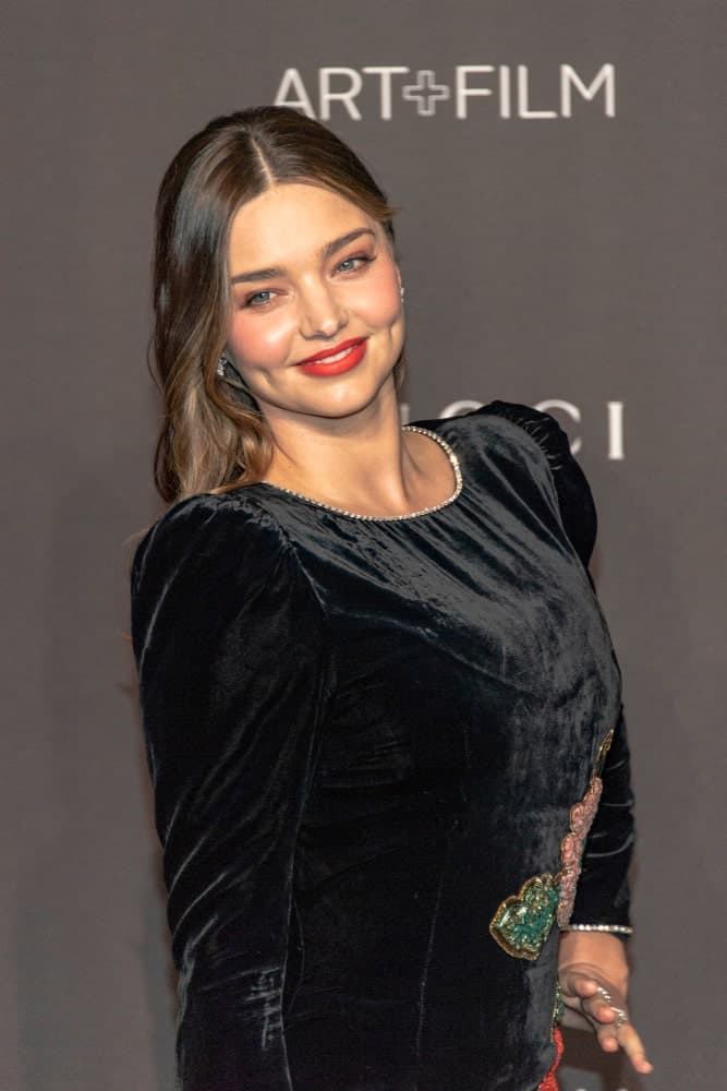 Miranda Kerr looking sophisticated in a black velvet dress along with her brunette loose hair styled with subtle curls and middle parting. This was taken during the 2018 LACMA Art+Film Gala Honoring Catherine Opie + Guillermo Del Toro on November 3rd.