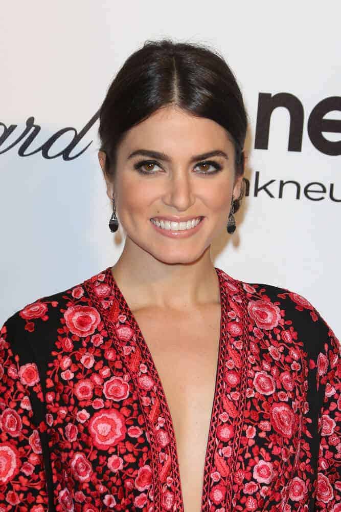 Nikki Reed proved that simplicity is beauty with her center-parted, low ponytail that she wore during the Elton John AIDS Foundation Presents 22nd Academy Awards Viewing Party, March 2, 2014.