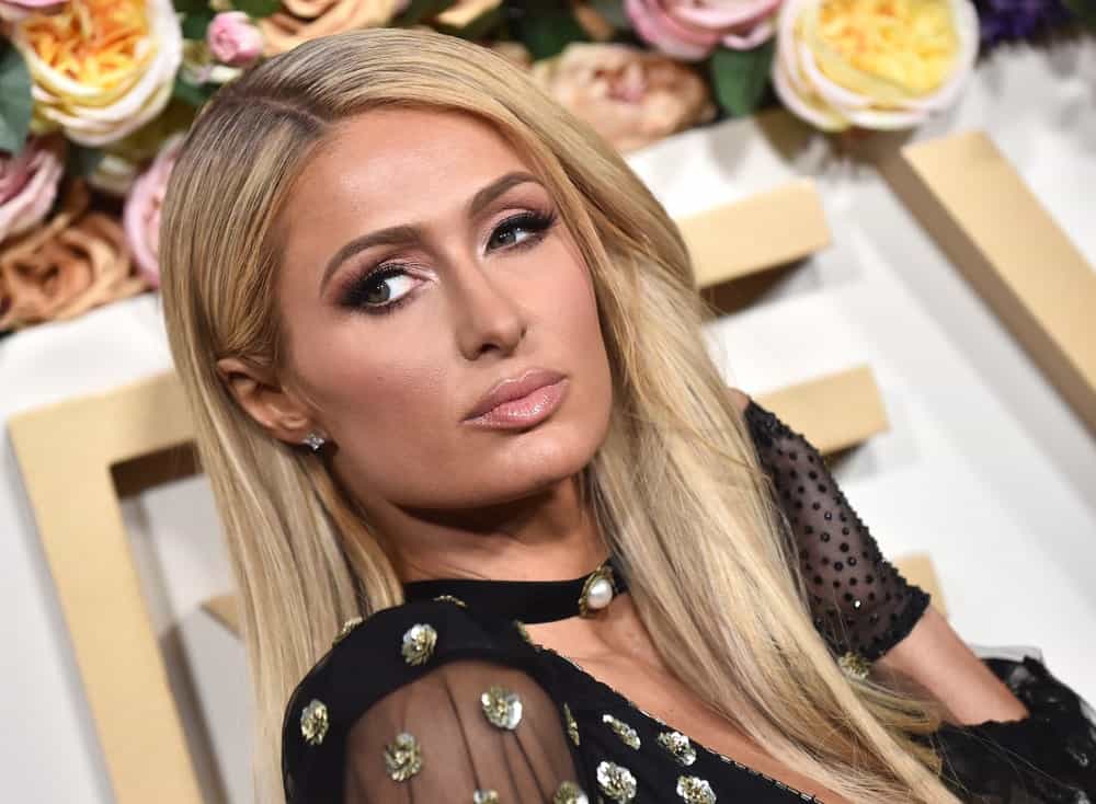 Paris Hilton sported a loose straight hairstyle during the 2019 REVOLVE Awards on November 15, 2019. She complemented it with a black choker dress inlaid with floral embellishments.