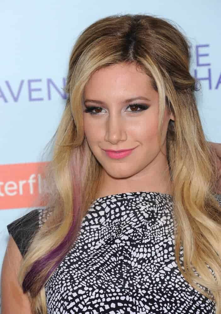 The actress made the typical half-up style with tendrils a little bit trendier by accenting a small portion of her hair with a violet dye. This look was worn last February 5, 2013 for the premiere of Safe Haven.