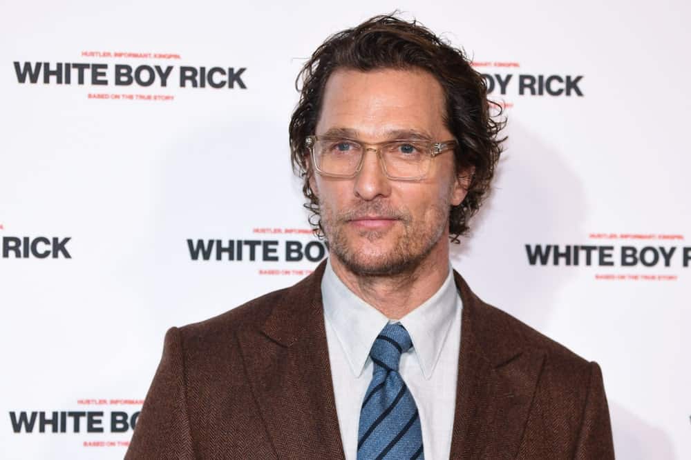 Last November 27, 2018, Matthew McConaughey attended the "White Boy Rick" screening at the Picturehouse Central in London wearing a dark brown suit and a sexy but messy side-parted wavy dark curls complemented with smart colorless spectacles.
