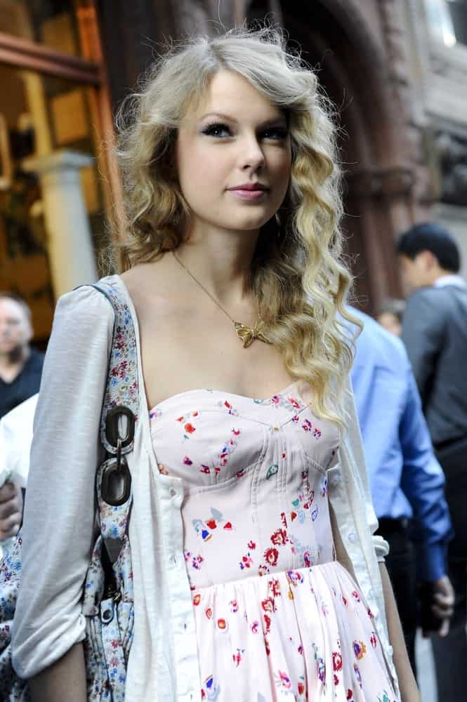 Taylor Swift leaves Olde Good Things out and about for CELEBRITY CANDIDS on May 5, 2010. She wore a cute printed dress along with a tousled curly hairstyle.