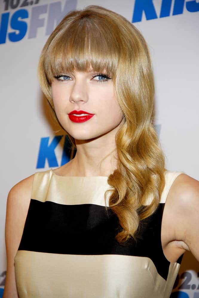 Taylor Swift gathered her blonde wavy hair on one side during the KIIS FM's 2012 Jingle Ball held at the Nokia Theatre L.A. Live held on December 3rd.