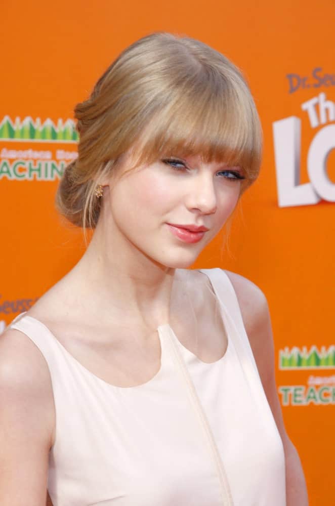 Taylor Swift tied her blonde locks in a loose low bun with bangs during the Los Angeles Premiere of "Dr. Suess' The Lorax" held on February 19, 2012.