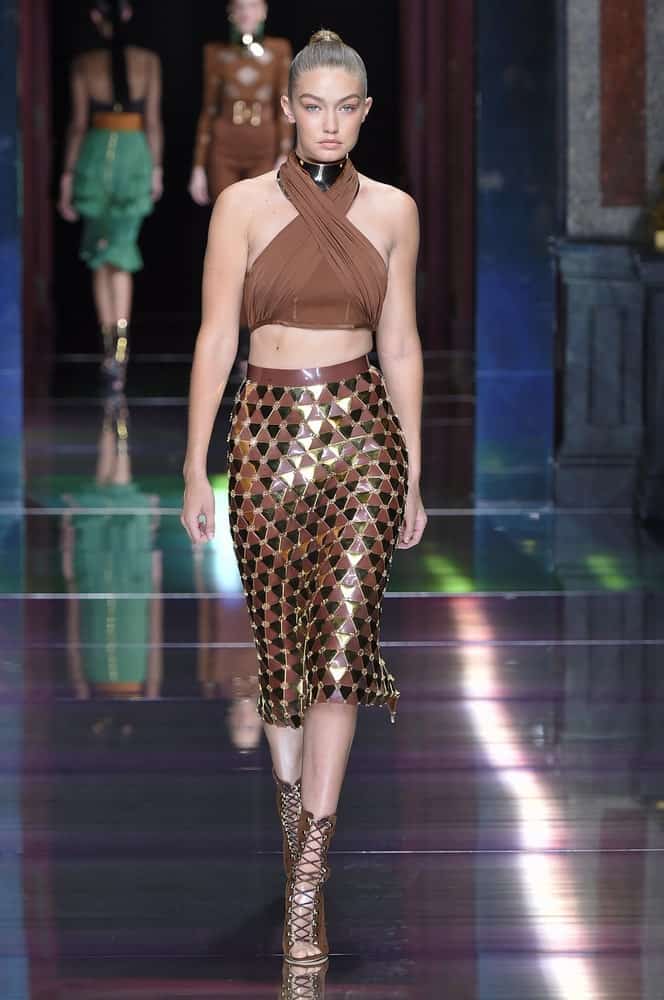 The beautiful bone structure of Gigi Hadid was emphasized with her slick high bun when she walked the runway during the Balmain show on October 1, 2015, in Paris, France.