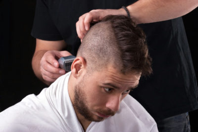 Man getting mohawk style haircut