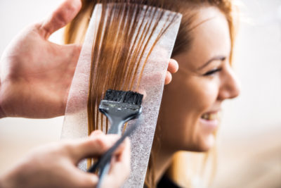 Woman getting highlights put into hair