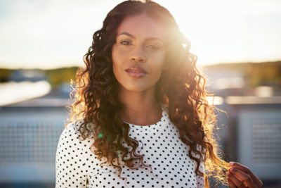 Attractive woman with long, black and curly hair