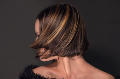 Dark, short hair with blonde highlights.