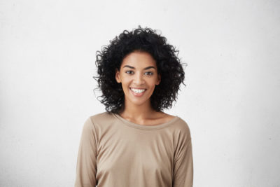 Woman with short, curly hair.