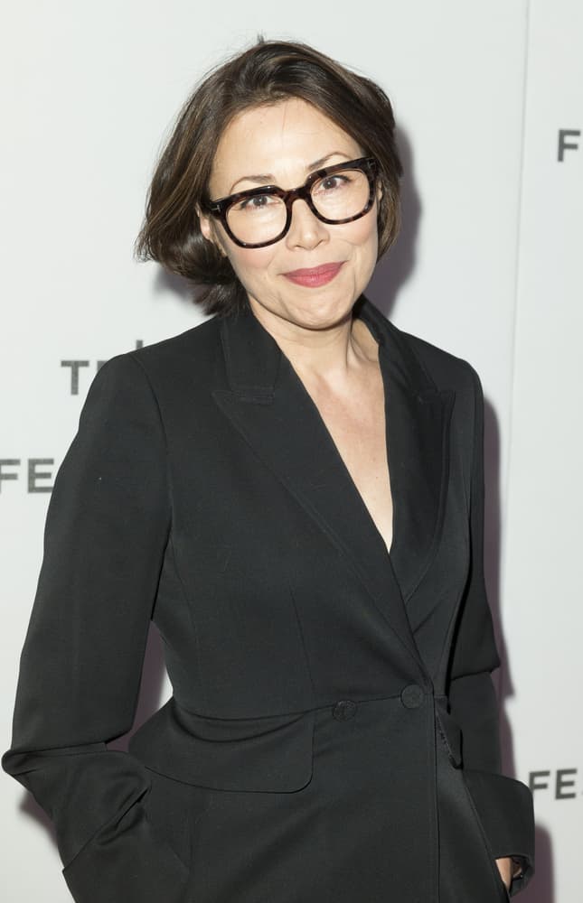 This hairstyle, modeled by Ann Curry, features a mid-length messy bob that is supplemented with soft curls and waves towards the back of the head. In addition to these compliments, the hairstyle is dark brown colored with the addition of chestnut and light brown highlights.