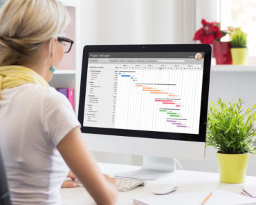 Hair salon owner working at comptuer on business software platform