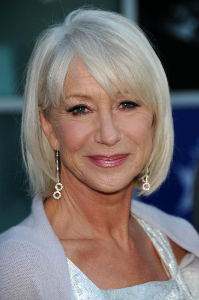 This twelfth hairstyle modeled by Helen Mirren features a soft, silver-colored bob that is softly curled inwards, towards the face, at the ends of the hair strands. In addition to the classy, silver hair color, the style features tousled, tapered-cut bangs that hang in different directions of the face.