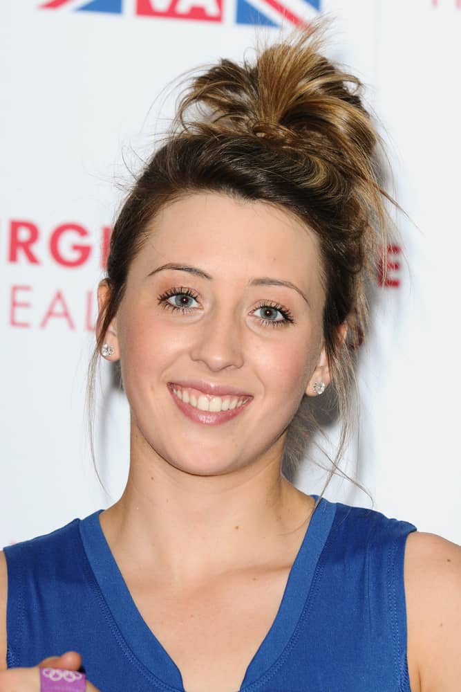 Jade Jones hairstyle is young, fresh, and easy to do. Flip your hair over and gather it high on your head. Loop the hair through a hair tie leaving a few inches out. Fan the loop and pull out a couple of strands just in front of the ears to frame the face.