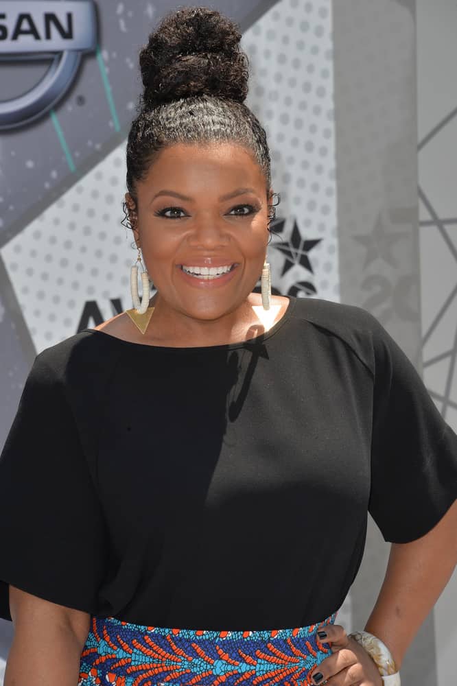 Working with your natural texture can make a beautiful up-do. Take a cue from Yvette Nicole Brown’s style and add some moisturizing hair serum before brushing your hair up into a hair tie. Loop your hair through once and wrap the ends around the base. Fan out the loop to finish the look.