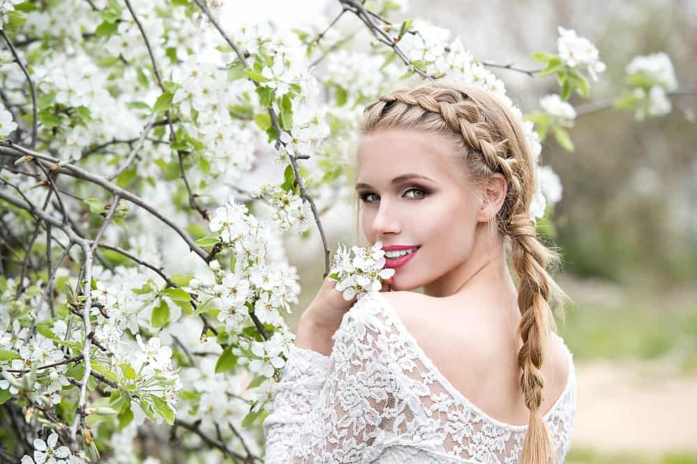 This hairdo is more ‘girl next door’ if that’s the vibe you’re going for. With a waterfall braid that continues down the back of the head, this is a more casual hairdo that you can still dress up with the right makeup and dress. 