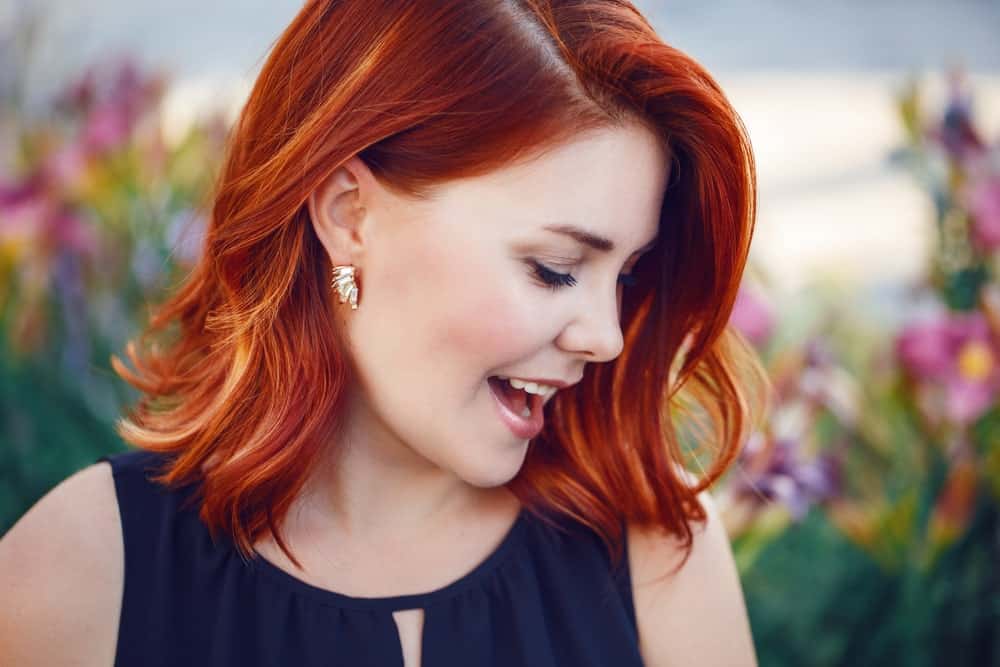 Starting with a dark red shade and ending with pale orange tips, this beautiful flame-colored balayage is the perfect representation of autumn.