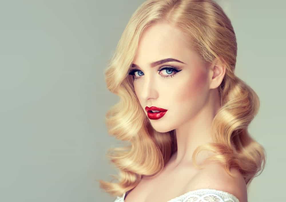 You know what goes best with a good red lipstick? Classic Hollywood curls. These curls look great swept off to the side and can be a great complement to an Old World glamor style. 