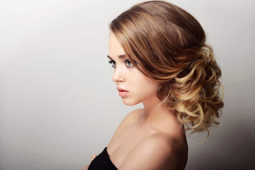  Another timeless look is a sleek, backcombed updo with softer curls towards the bottom. It makes any hairdo look just that much more elegant. 