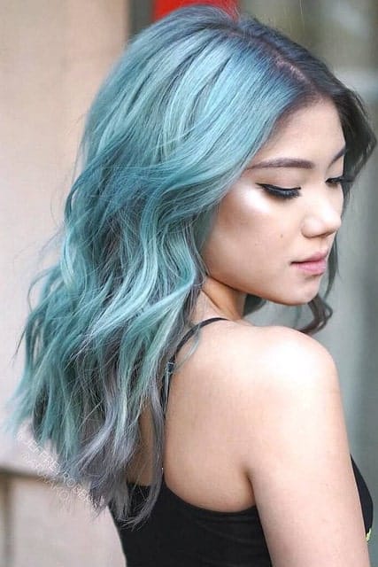 Right along with the silver hair, the anime hair look is also trending these days. This young woman is sporting a full head of turquoise, lavender, silver and aquamarine balayage making her look like Bulma from Dragon Ball Z.