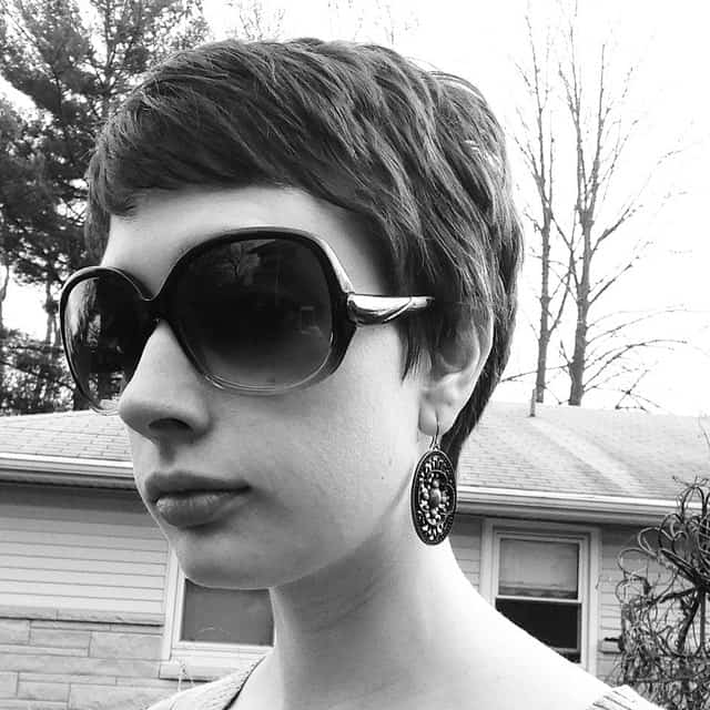 https://www.flickr.com/photos/119492517@N03/15256912921/ This pixie cut is super-short in the back and longer in the front, like a reverse mullet or tellum. This is a perfect compromise for those people who want to keep their hair off their nape but also want to frame their forehead.