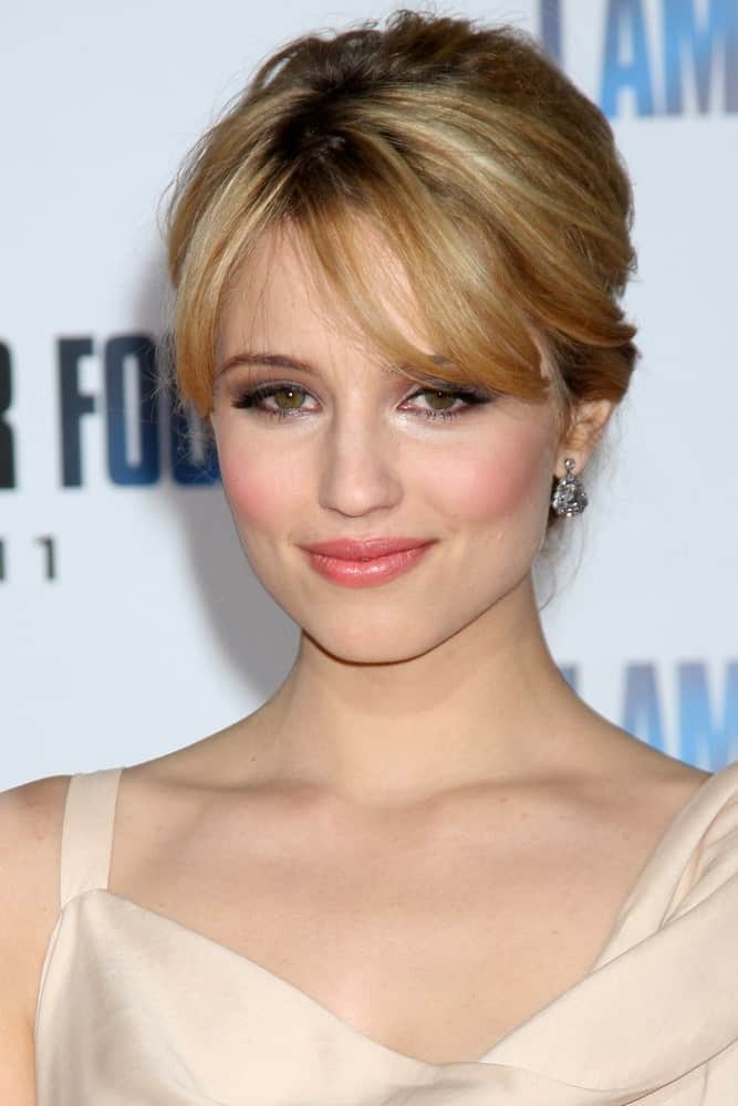 Don’t confuse this look for short hair! Dianna Agron looks absolutely lovely with her long hair tied at the back in a stylish bun while her bangs cover the forehead. While most other hairstyles involve messy buns, this one keeps all your hair wrapped and nicely tucked in the bun!  