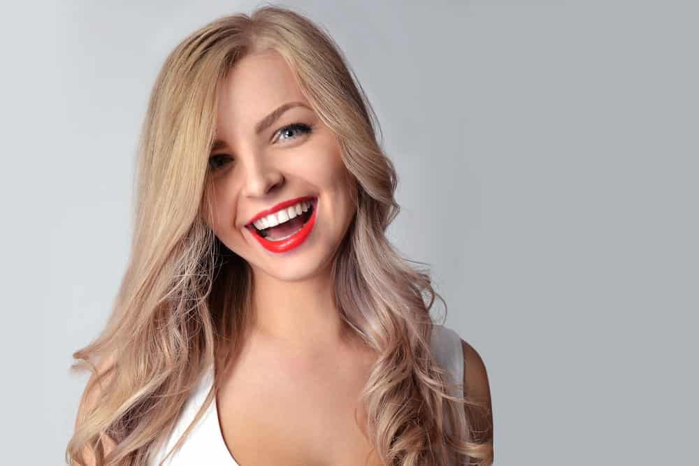 Your fabulously colored hair should aim to be a statement and head-turner at every party. Get a lovely balayage of sand and rose-gold colors like this young woman. For a great party look, quickly give your locks a tousled look with five minutes of blow dry.