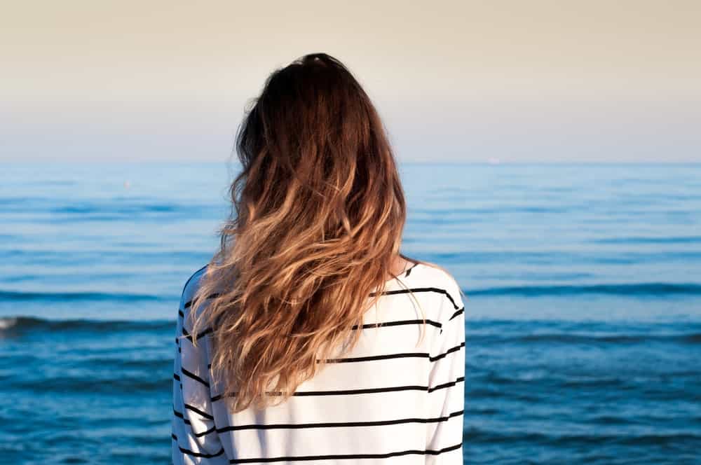 For a classic beach-wave look, leave your hair alone. By that we mean don’t try to tame the frizz or manage the waves – just let it be. It’ll give that classic, tousled ‘just left the beach’ effect. 