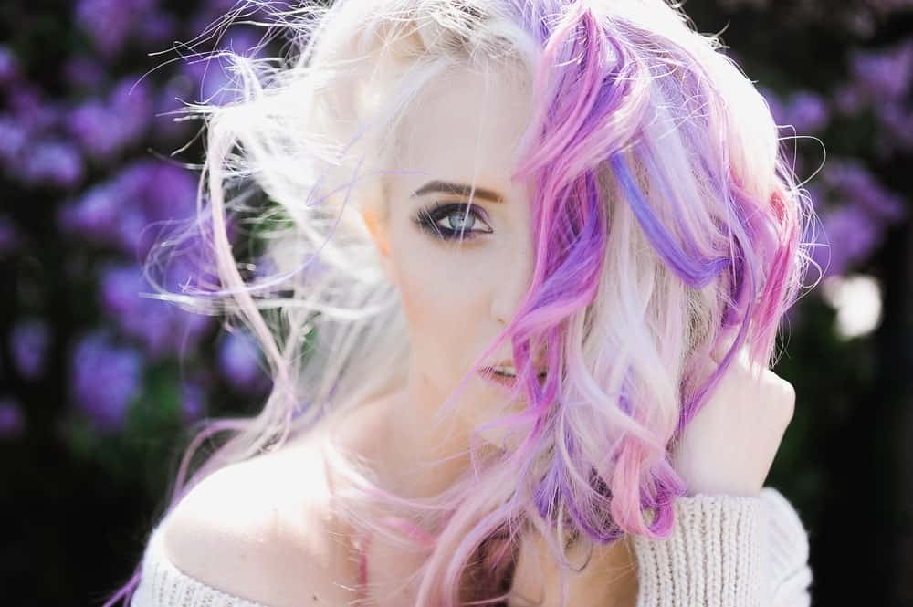 This model’s platinum blonde locks blended with pink and purple strands are the perfect homage to the mythical creature, the unicorn. The hairstyle looks particularly good on people with very fair skin, although it works great with all skin tones.