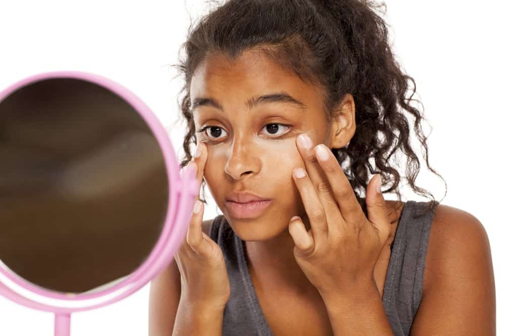 Woman applying concealer