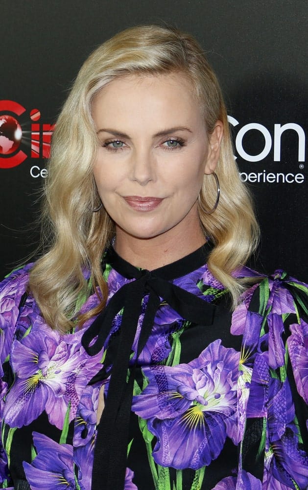 Charlize Theron looked charming in a floral dress paired with a permed hairstyle that's side-parted. This look was worn during the Focus Features Luncheon And Studio Program Celebrating 15 Years held on March 29, 2017.